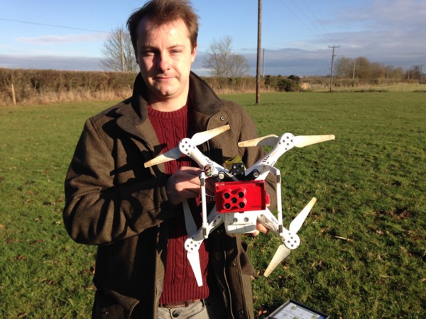 Henry Webber holds the drone and the RedEdge multispectral sensor